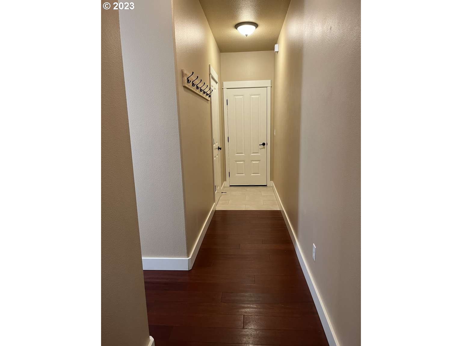 199 Northwest Camp Ireland Street Hillsboro, OR 97124 - Photo 5 of 36 a view of a hallway with wooden floor