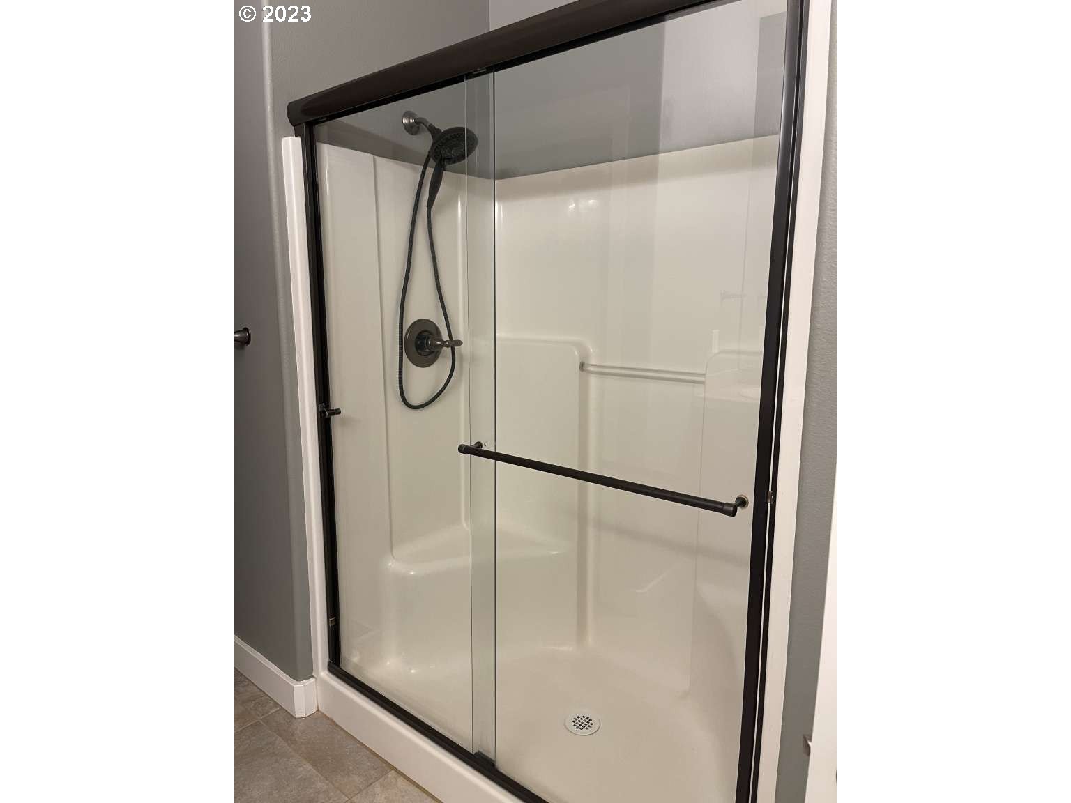 199 Northwest Camp Ireland Street Hillsboro, OR 97124 - Photo 9 of 36 a bathroom with a glass shower door