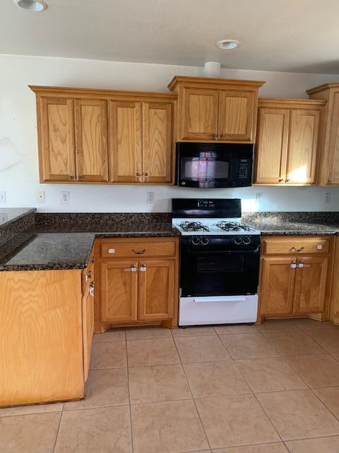 3610 South Harrison Street Amarillo, TX 79110 - Photo 3 of 8 a kitchen with granite countertop a stove top oven sink and cabinets