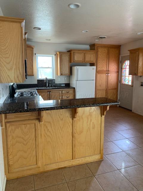 3610 South Harrison Street Amarillo, TX 79110 - Photo 4 of 8 a kitchen with granite countertop white cabinets and stainless steel appliances