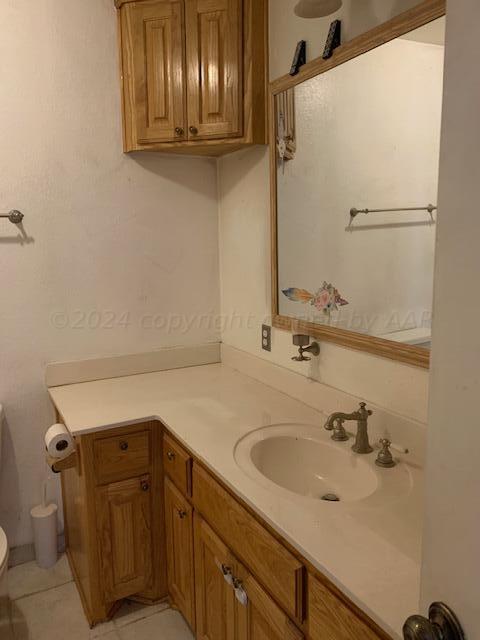 3610 South Harrison Street Amarillo, TX 79110 - Photo 7 of 8 a bathroom with a sink and a mirror