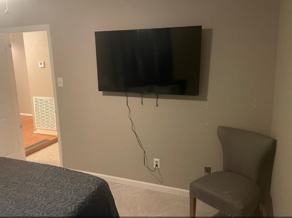 5711 Toddington Road Humble, TX 77346 - Photo 15 of 35 a bedroom with a bed and flat screen tv