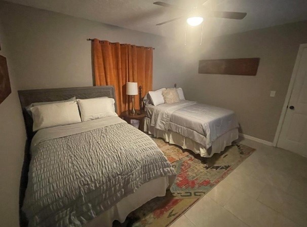 5711 Toddington Road Humble, TX 77346 - Photo 23 of 35 a bedroom with two beds and painting on the wall