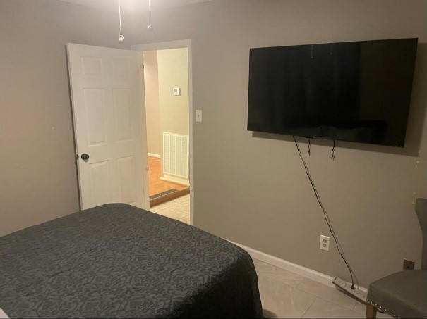 5711 Toddington Road Humble, TX 77346 - Photo 26 of 35 a bedroom with a bed and a flat screen tv