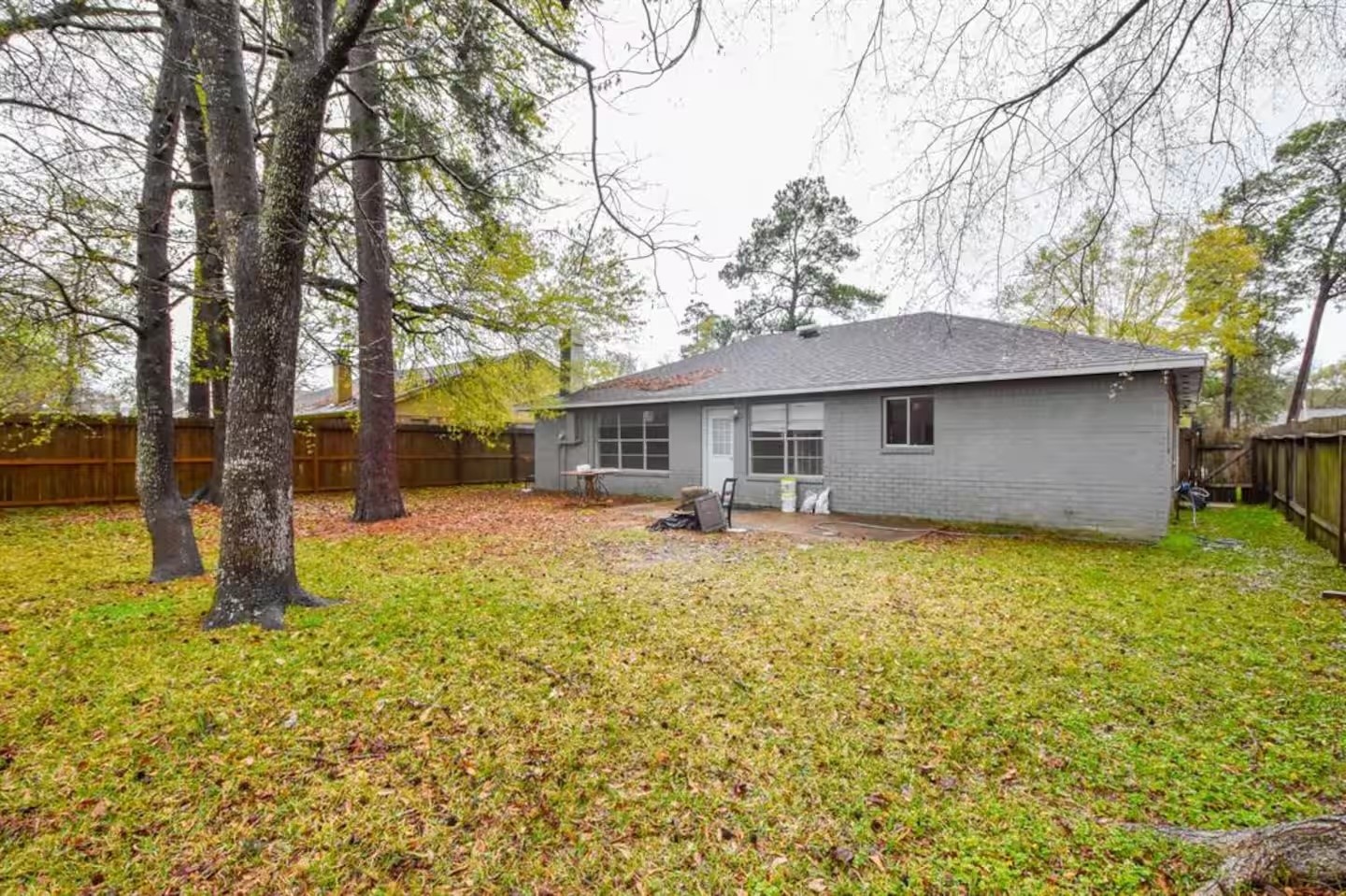 5711 Toddington Road Humble, TX 77346 - Photo 34 of 35 a backyard of a house with table and chairs under an umbrella