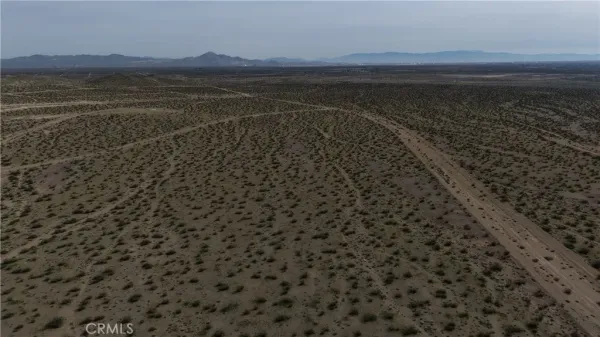 a view of an ocean beach and mountain