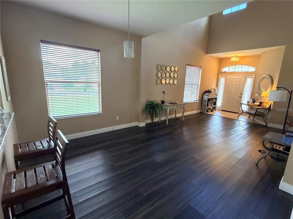 13250 Mandalay Place Spring Hill, FL 34609 - Photo 5 of 28 a living room with furniture and a wooden floor