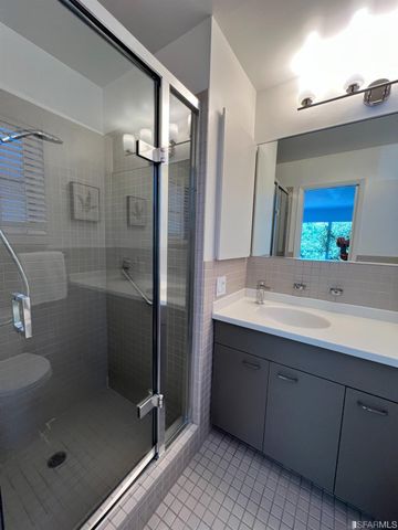 a bathroom with a shower sink and mirror