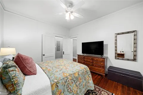 a bedroom with a bed and a flat screen tv