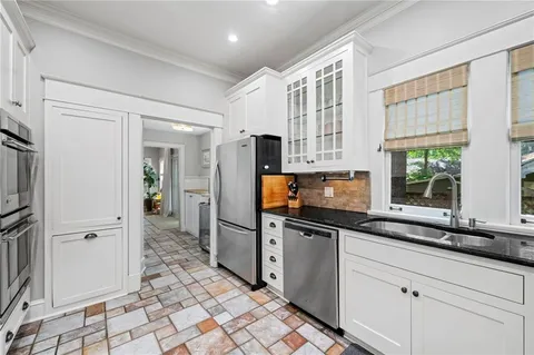 a kitchen with stainless steel appliances a refrigerator sink and cabinets