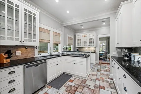 a kitchen with stainless steel appliances a sink stove and cabinets