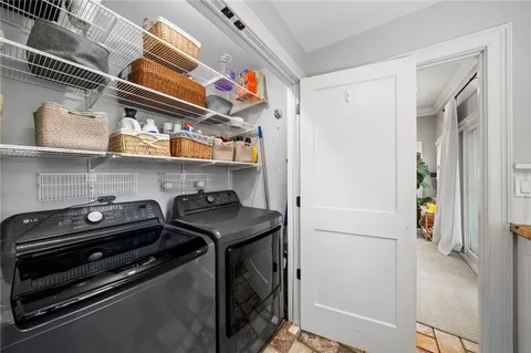 a utility room with stainless steel appliances and cabinets