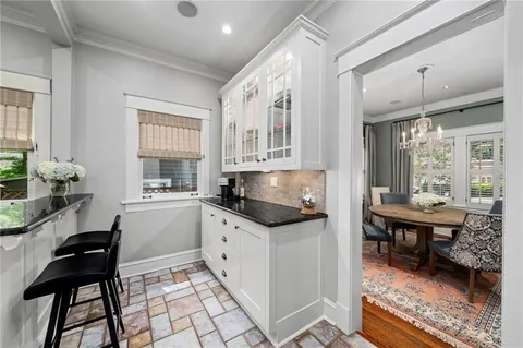 a kitchen with granite countertop a sink and a stove top oven
