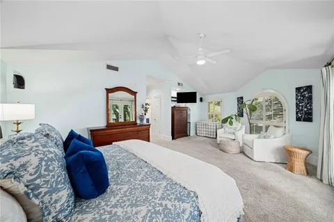 a bedroom with a large bed and a couch