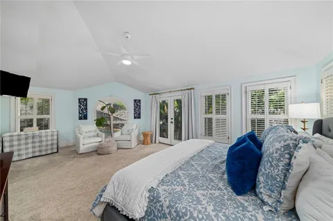 a spacious bedroom with a bed a couch and dresser