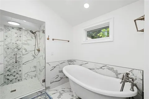 a bathroom with a bathtub and shower