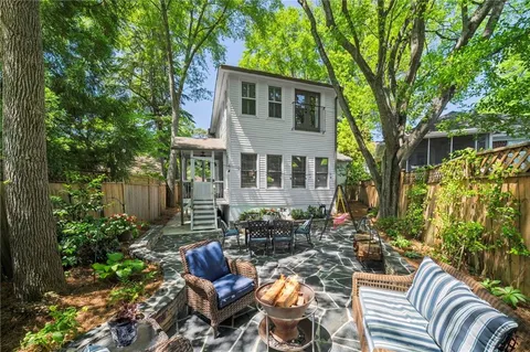a view of a patio with couches chairs and a potted plant