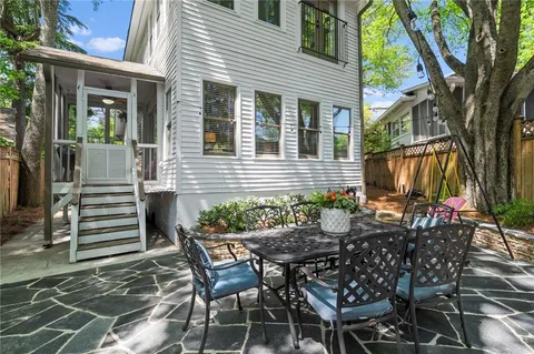 a view of a patio with table and chairs and potted plants