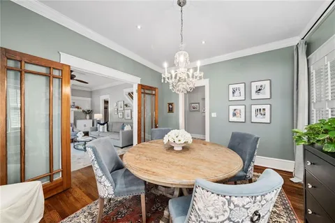 a view of a dining room with furniture and chandelier