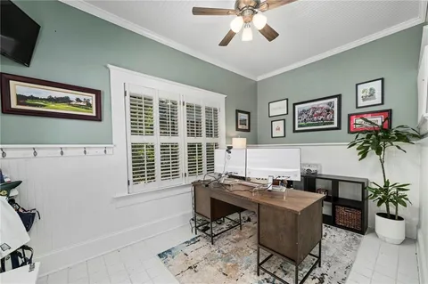 a view of a workspace with furniture and a potted plant