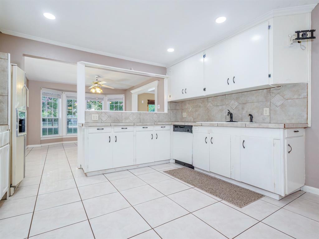 4002 Austin Avenue Brownwood, TX 76801 - Photo 6 of 34 a kitchen with a sink a stove and cabinets
