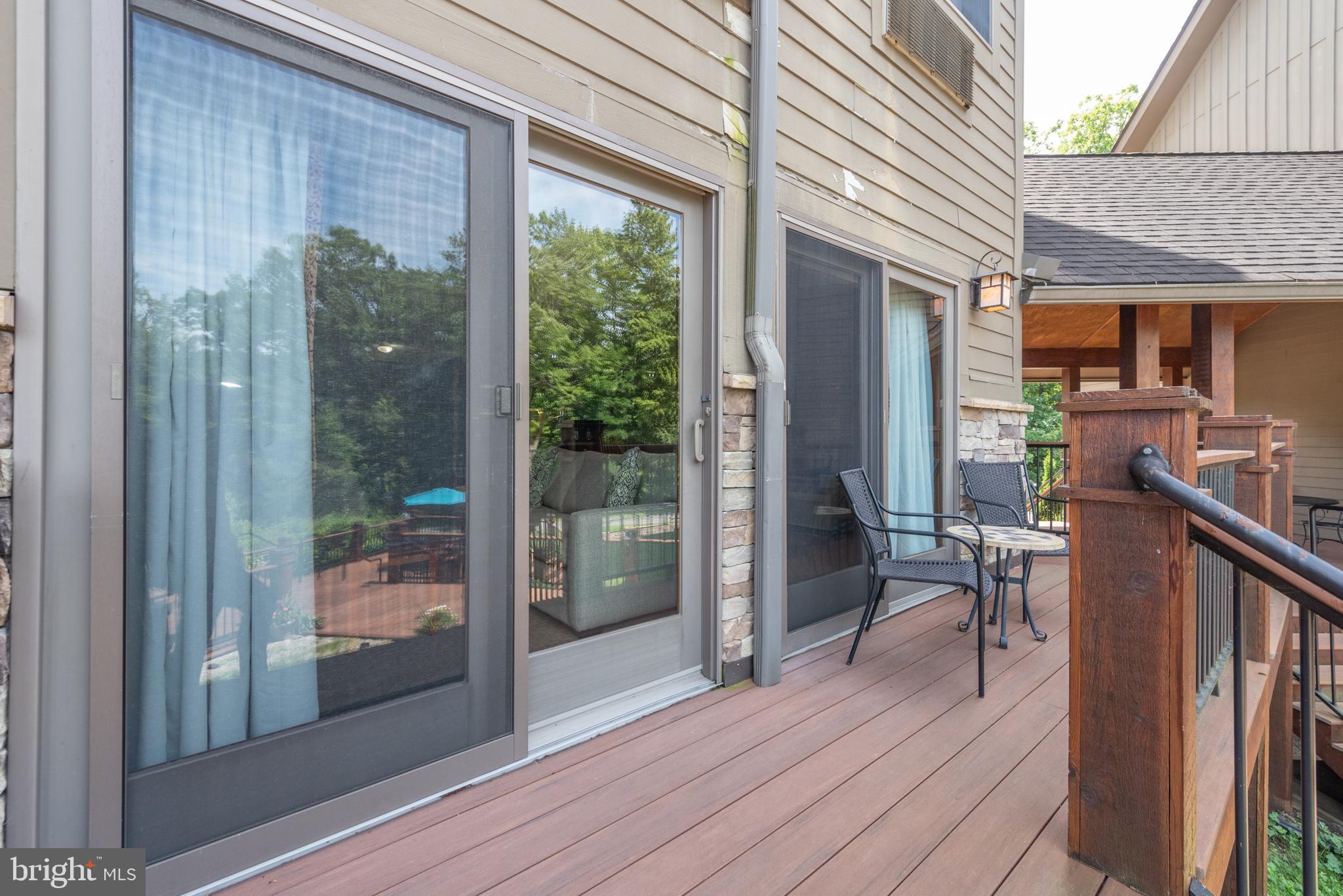 565 Glendale Road, Unit 125 Oakland, MD 21550 - Photo 21 of 55 a view of a patio with table and chairs and wooden floor