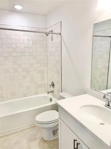 a bathroom with a sink a toilet and a bathtub