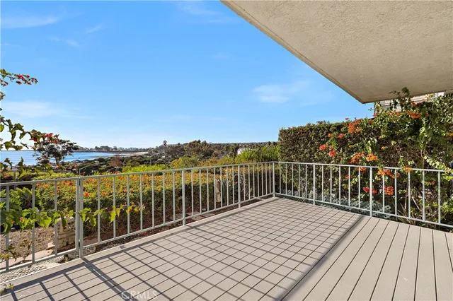a balcony with wooden floor and city view