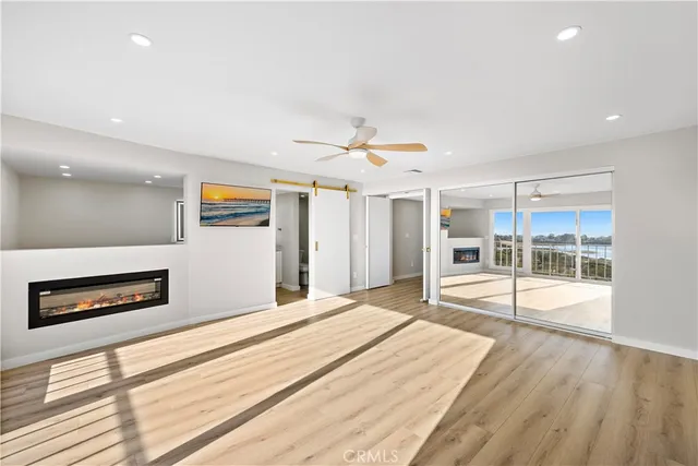 a spacious bathroom with a granite countertop sink a toilet a mirror and vanity