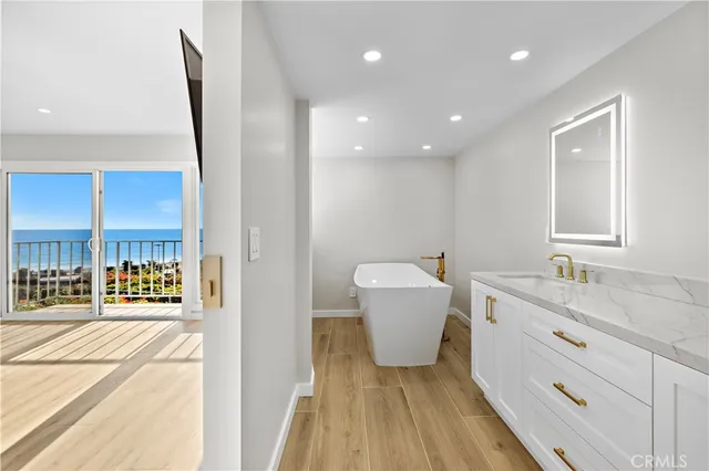 a spacious bathroom with a granite countertop sink a toilet a mirror and vanity