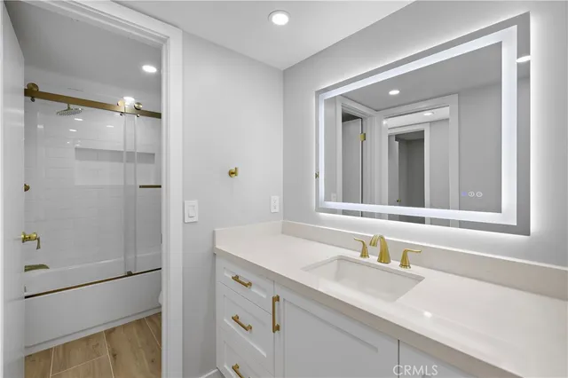 a bedroom with a bed and painting on the wall