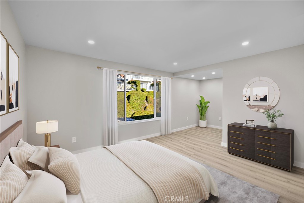 25836 Dana Bluff West, Unit 32 Dana Point, CA 92624 - Photo 37 of 47 a bedroom with a bed and painting on the wall