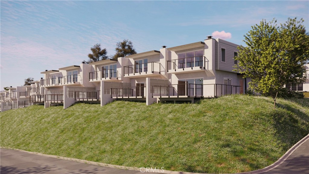 25836 Dana Bluff West, Unit 32 Dana Point, CA 92624 - Photo 39 of 47 a view of a big house with a big yard plants and large trees