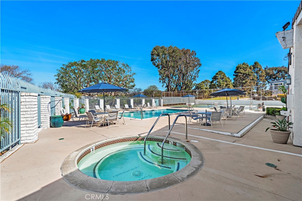 25836 Dana Bluff West, Unit 32 Dana Point, CA 92624 - Photo 44 of 47 a view of a swimming pool with a patio