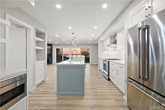 a kitchen with refrigerator and microwave