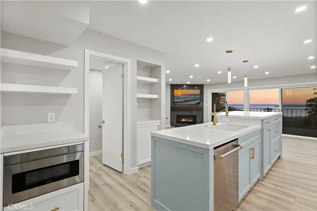 a kitchen with a sink and a stove top oven