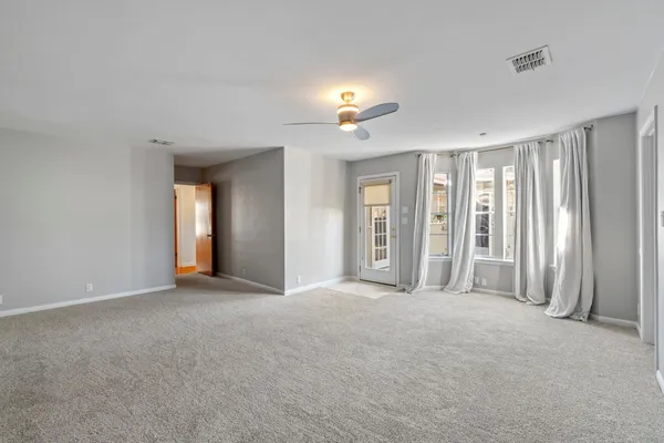 a view of empty room with a fireplace