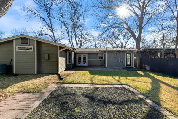 a view of a house with pool and a yard in front of it