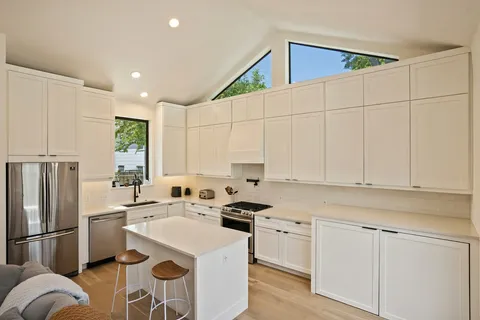 a kitchen with a sink stove and cabinets