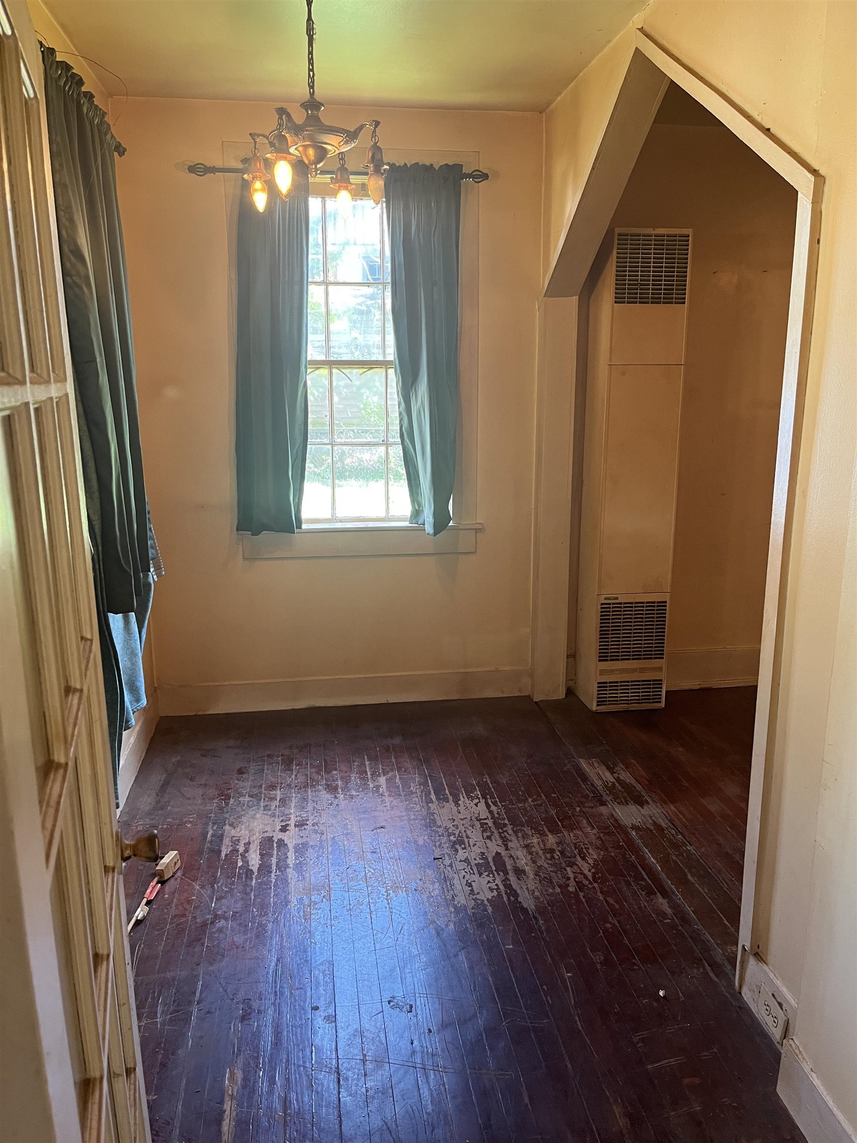 211 4th Street Mobile, AL 36611 - Photo 5 of 34 Unfurnished dining area featuring dark wood finished floors, a heating unit, and a chandelier