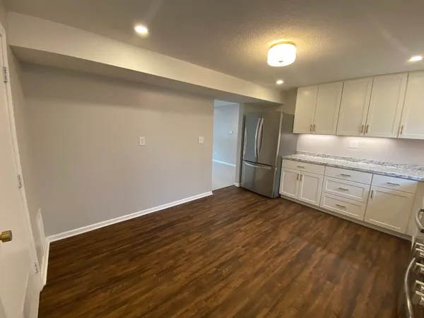 a view of a kitchen with a sink and a refrigerator