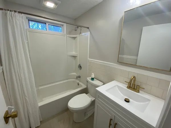 a bathroom with a sink toilet and shower
