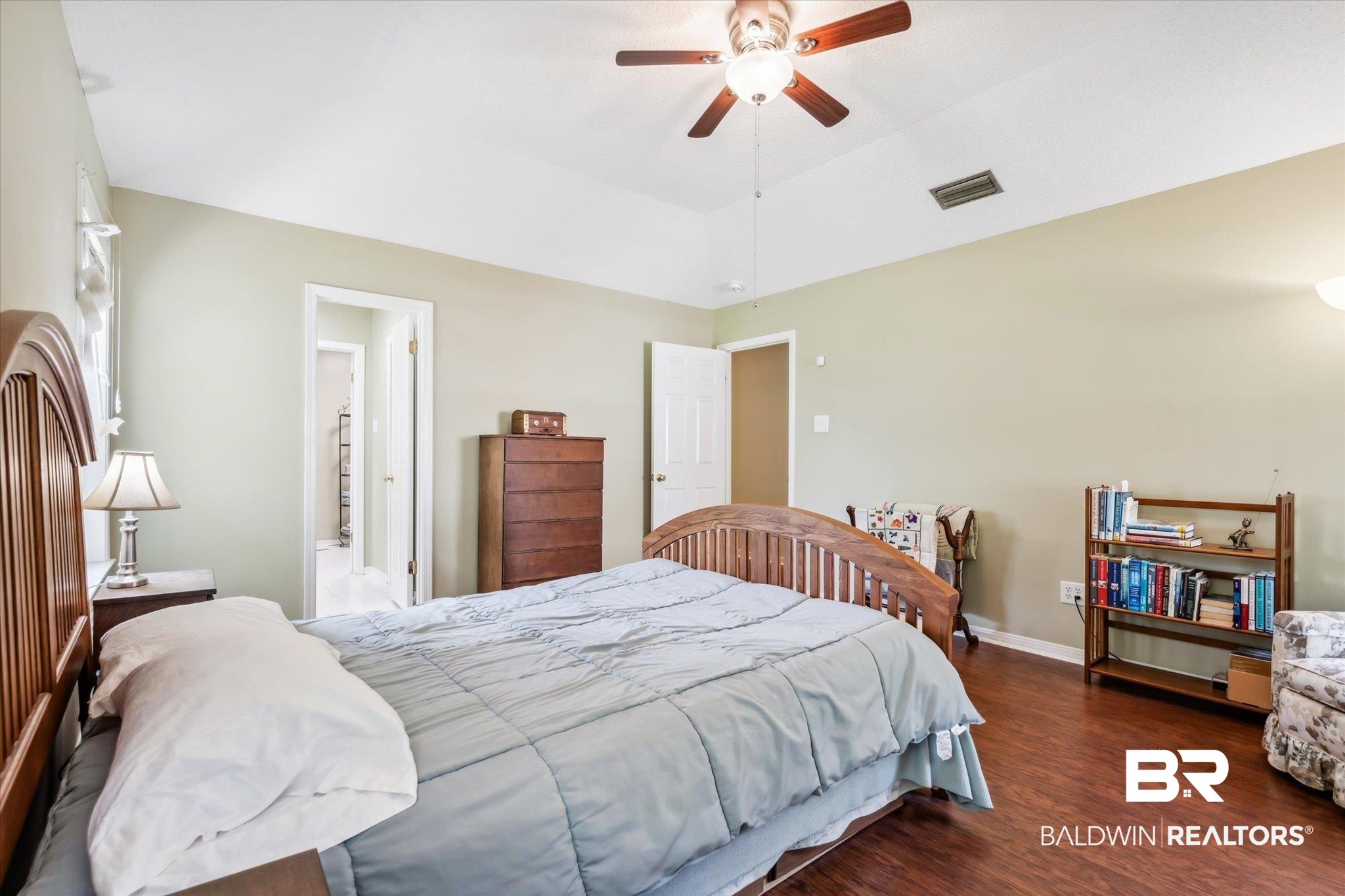 8710 Three Notch Road Mobile, AL 36619 - Photo 14 of 30 Bedroom featuring ceiling fan, dark hardwood / wood-style flooring, and a raised ceiling