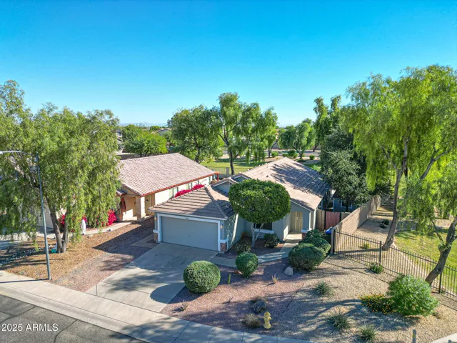 an aerial view of residential houses with outdoor space and street view