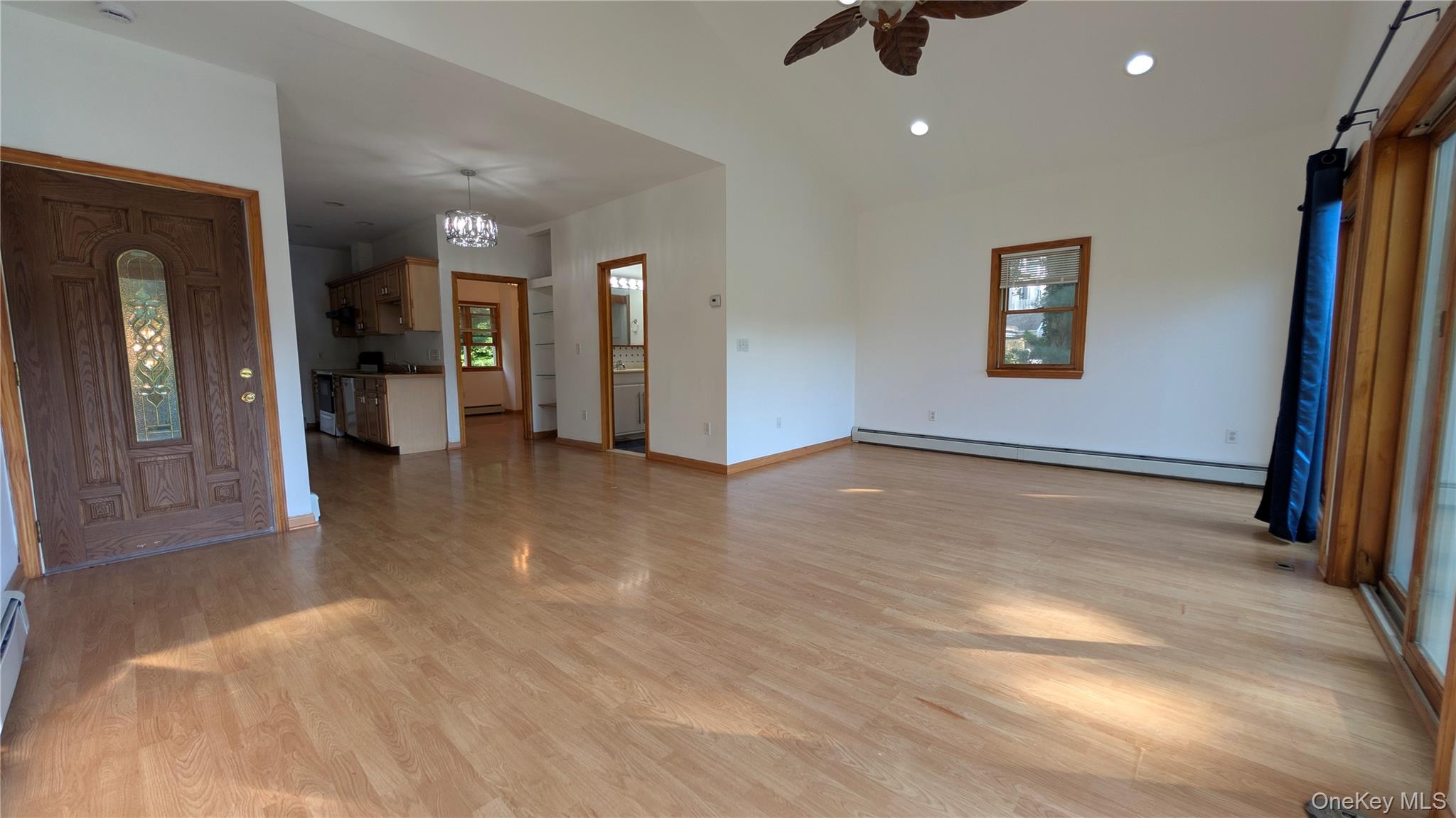 169 Shear Hill Road Mahopac, NY 10541 - Photo 8 of 31 Unfurnished living room featuring a baseboard heating unit, light wood finished floors, recessed lighting, ceiling fan, and healthy amount of natural light