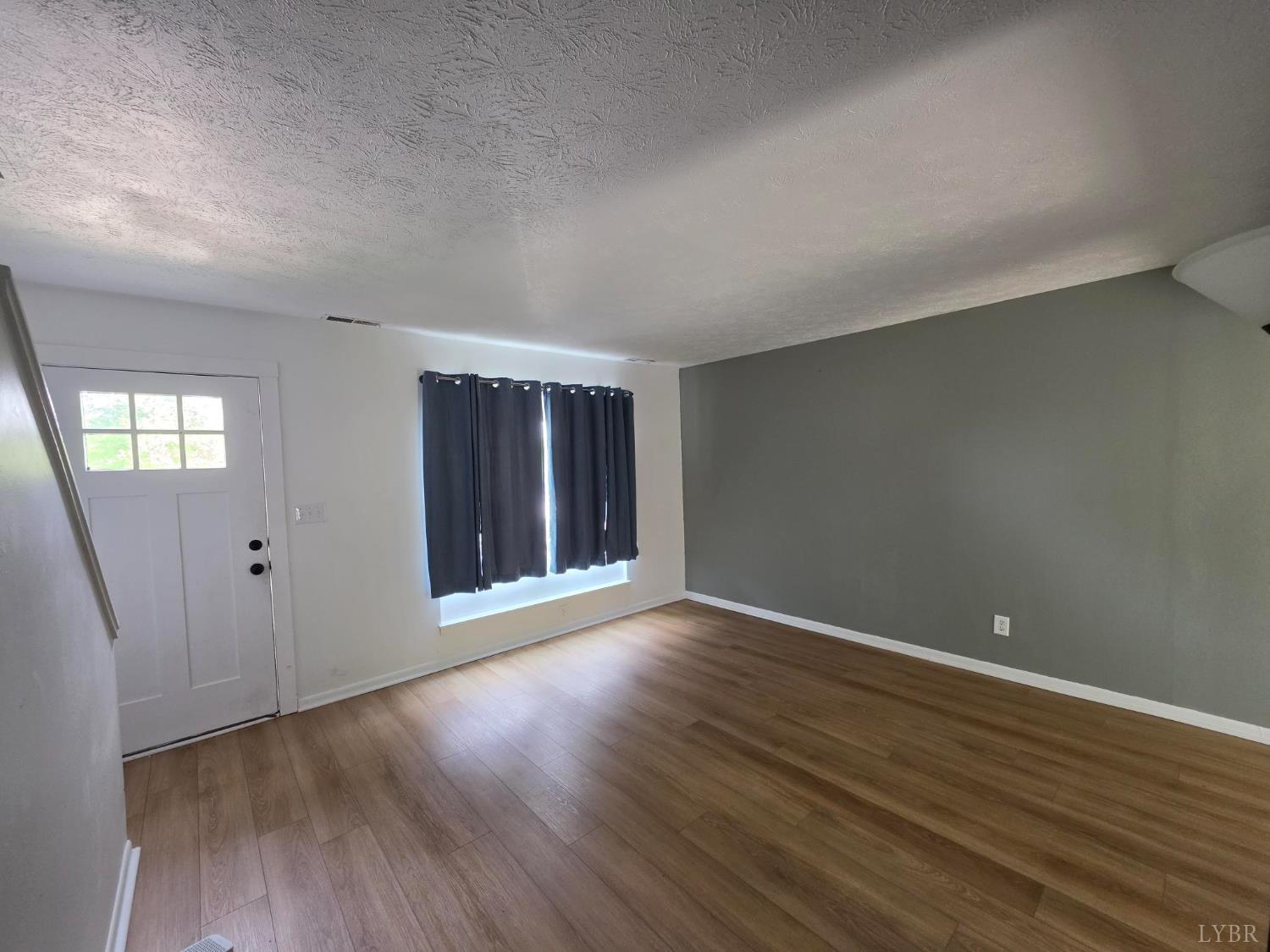 178 Dulwich Drive, Unit 178 Amherst, VA 24521 - Photo 7 of 17 an empty room with wooden floor and windows