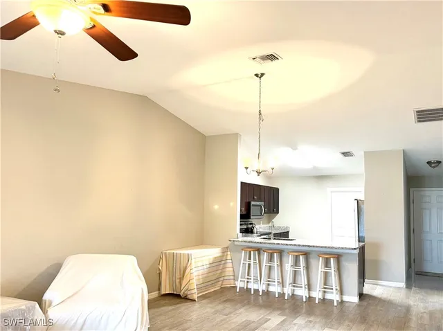 a kitchen with granite countertop a sink a stove and wooden cabinets