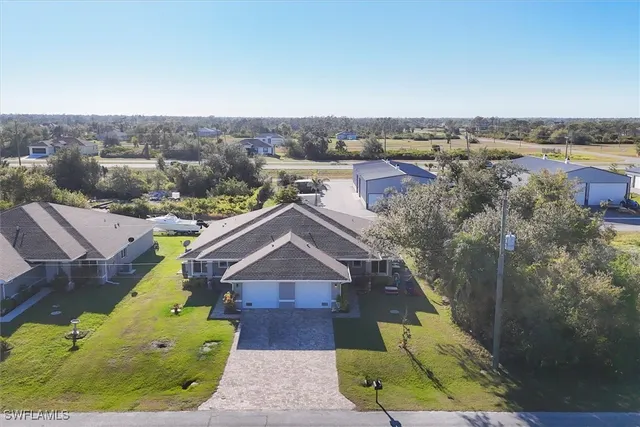 an aerial view of a house with a big yard