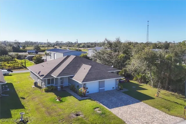 an aerial view of a house with a yard