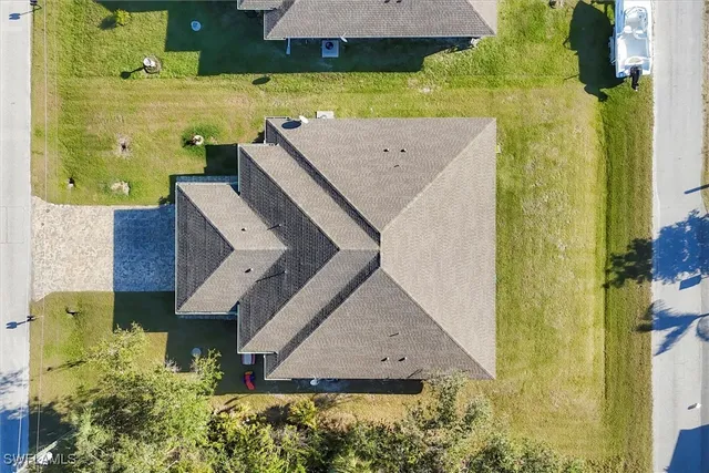 an aerial view of a house with a yard